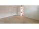 Neutral carpeted bedroom with white walls, bi-fold closet, and doorway to the rest of the home at 8171 E Del Caverna Dr, Scottsdale, AZ 85258