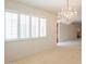 Bright dining area illuminated by a crystal chandelier and filled with natural light from shuttered windows at 8171 E Del Caverna Dr, Scottsdale, AZ 85258
