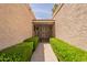 Inviting front entrance featuring a decorative security gate and well-maintained landscaping at 8171 E Del Caverna Dr, Scottsdale, AZ 85258