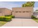 Attractive home exterior with a two-car garage, well-manicured bushes, and a clean driveway at 8171 E Del Caverna Dr, Scottsdale, AZ 85258