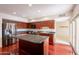 Open kitchen featuring stainless appliances, island, hardwood floors, and a bright atmosphere at 8171 E Del Caverna Dr, Scottsdale, AZ 85258