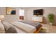 Serene main bedroom features a king bed, a sleek dresser, and a view into the adjoining bathroom at 8171 E Del Caverna Dr, Scottsdale, AZ 85258