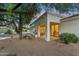 Exterior of white home with large patio and a desert landscaped backyard at dusk at 8196 E Sunnyside Dr, Scottsdale, AZ 85260