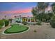 View of backyard with pool, putting green and landscaped with desert vegetation at sunset at 8196 E Sunnyside Dr, Scottsdale, AZ 85260