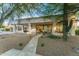 Expansive backyard with desert landscaping, a stone pathway and a covered patio providing a tranquil outdoor space at 8196 E Sunnyside Dr, Scottsdale, AZ 85260