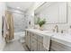 Stylish bathroom featuring double vanity, marble tile, and a shower at 8196 E Sunnyside Dr, Scottsdale, AZ 85260