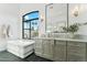 Bathroom featuring a soaking tub and large arched window with lots of natural light at 8196 E Sunnyside Dr, Scottsdale, AZ 85260