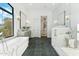 Bright bathroom featuring a soaking tub, a walk-in shower, and dual vanities at 8196 E Sunnyside Dr, Scottsdale, AZ 85260