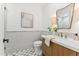 Elegant powder room featuring a wood vanity, marble tile, and stylish fixtures at 8196 E Sunnyside Dr, Scottsdale, AZ 85260