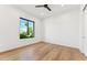 Bright bedroom with hardwood floors, a ceiling fan, and a large window at 8196 E Sunnyside Dr, Scottsdale, AZ 85260