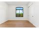 Bright bedroom with hardwood floors, a large window, and a closet at 8196 E Sunnyside Dr, Scottsdale, AZ 85260