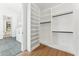 Spacious walk-in closet with custom shelving, hanging rods, and wood flooring at 8196 E Sunnyside Dr, Scottsdale, AZ 85260