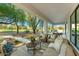Inviting covered patio featuring comfortable seating and views of the lush backyard and golf course at 8196 E Sunnyside Dr, Scottsdale, AZ 85260