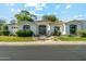 Charming single-story home with a red tile roof, lush landscaping, and a black trimmed window at 8196 E Sunnyside Dr, Scottsdale, AZ 85260