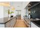 Modern kitchen with a stainless steel refrigerator, large island, and light wood flooring at 8196 E Sunnyside Dr, Scottsdale, AZ 85260
