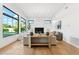 Spacious living room with hardwood floors, large windows, and a modern fireplace at 8196 E Sunnyside Dr, Scottsdale, AZ 85260
