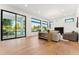 Spacious living room with hardwood floors, fireplace, and expansive sliding glass doors leading to outdoor area at 8196 E Sunnyside Dr, Scottsdale, AZ 85260