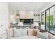 Inviting living room with a view of an open-concept kitchen featuring pendant lighting and modern appliances at 8196 E Sunnyside Dr, Scottsdale, AZ 85260