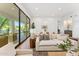 Bright living room featuring a comfortable sofa and large sliding doors, offering a seamless indoor-outdoor lifestyle at 8196 E Sunnyside Dr, Scottsdale, AZ 85260