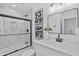 Modern bathroom with marble details, a black framed shower, and black fixtures at 8732 E Arlington Rd, Scottsdale, AZ 85250
