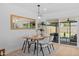 Dining area with table set for four, modern light fixture, and sliding glass doors to the backyard at 8732 E Arlington Rd, Scottsdale, AZ 85250