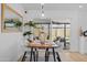 Dining area with modern light fixture, table set for four, and sliding glass doors to the outdoor living area at 8732 E Arlington Rd, Scottsdale, AZ 85250
