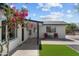 Charming home featuring manicured landscaping, colorful flowers, and inviting front entrance at 8732 E Arlington Rd, Scottsdale, AZ 85250