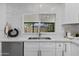 Bright kitchen features white cabinets, stainless steel appliances, and a view to the outside at 8732 E Arlington Rd, Scottsdale, AZ 85250