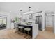 Bright kitchen features white cabinets, stainless steel appliances, skylight, and a large island with bar stool seating at 8732 E Arlington Rd, Scottsdale, AZ 85250