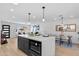 Open concept kitchen with island, dining table, and living area for a spacious entertaining layout at 8732 E Arlington Rd, Scottsdale, AZ 85250