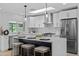Bright kitchen featuring white cabinets, stainless steel appliances, skylight, and a large island with bar stool seating at 8732 E Arlington Rd, Scottsdale, AZ 85250
