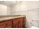 Bathroom featuring a wooden vanity with granite countertop, large mirror, and standard toilet at 930 N Mesa Dr # 1023, Mesa, AZ 85201