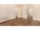 Empty bedroom with wood floors, neutral walls, a window, and standard electrical outlets at 930 N Mesa Dr # 1023, Mesa, AZ 85201