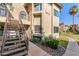 Attractive condo building with desert landscaping, private entrances, and staircase access at 930 N Mesa Dr # 1023, Mesa, AZ 85201
