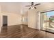 Spacious living room featuring wood floors, sliding doors to a balcony, and ample natural light at 930 N Mesa Dr # 1023, Mesa, AZ 85201