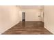 Spacious living room with wood floors and natural light from two windows at 930 N Mesa Dr # 1023, Mesa, AZ 85201