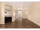 Inviting living area with fireplace, wood floors, neutral paint, and large mirror at 930 N Mesa Dr # 1023, Mesa, AZ 85201