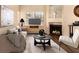 Cozy staged living room with a fireplace, plush seating, and modern decor at 930 N Mesa Dr # 1023, Mesa, AZ 85201