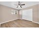 Bedroom features a closet, window, ceiling fan, and new hardwood flooring at 9639 W Cinnabar Ave # A, Peoria, AZ 85345
