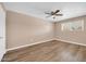 Bedroom with a large window and neutral walls with hardwood flooring at 9639 W Cinnabar Ave # A, Peoria, AZ 85345