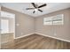 Bedroom featuring wood-look flooring, ceiling fan, and bright natural light at 9639 W Cinnabar Ave # A, Peoria, AZ 85345