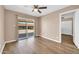 Bedroom with hardwood floors and natural light, featuring a sliding glass door at 9639 W Cinnabar Ave # A, Peoria, AZ 85345