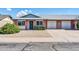 Charming single-story home with brick facade, a green door, and well-maintained landscaping at 9639 W Cinnabar Ave # A, Peoria, AZ 85345