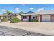 Charming single-story home with brick facade, a green door, and well-maintained landscaping at 9639 W Cinnabar Ave # A, Peoria, AZ 85345