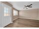 Bright living room with vinyl floors, a ceiling fan, and a view of the outdoors at 9639 W Cinnabar Ave # A, Peoria, AZ 85345