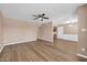 Spacious living room with vinyl floors and ceiling fan, with an open floor plan at 9639 W Cinnabar Ave # A, Peoria, AZ 85345