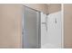 Bathroom shower with glass door and mounted shower head; neutral paint at 9639 W Cinnabar Ave # A, Peoria, AZ 85345