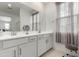 Bright bathroom featuring double sinks, modern fixtures, and a large mirror at 9901 E Tamery Ave, Mesa, AZ 85212