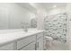 Bright bathroom featuring a vanity and patterned shower curtain at 9901 E Tamery Ave, Mesa, AZ 85212