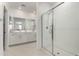 Bright bathroom featuring double sinks, glass-enclosed shower, and modern fixtures at 9901 E Tamery Ave, Mesa, AZ 85212